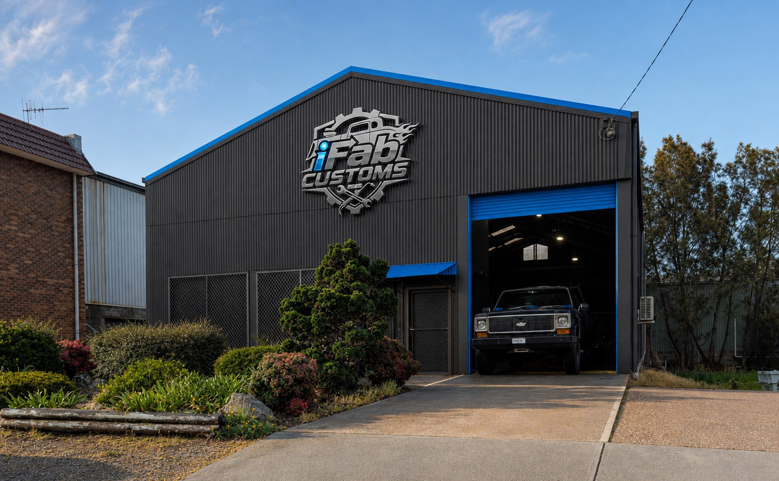 The iFab Customs shed in Taree with the roller door open